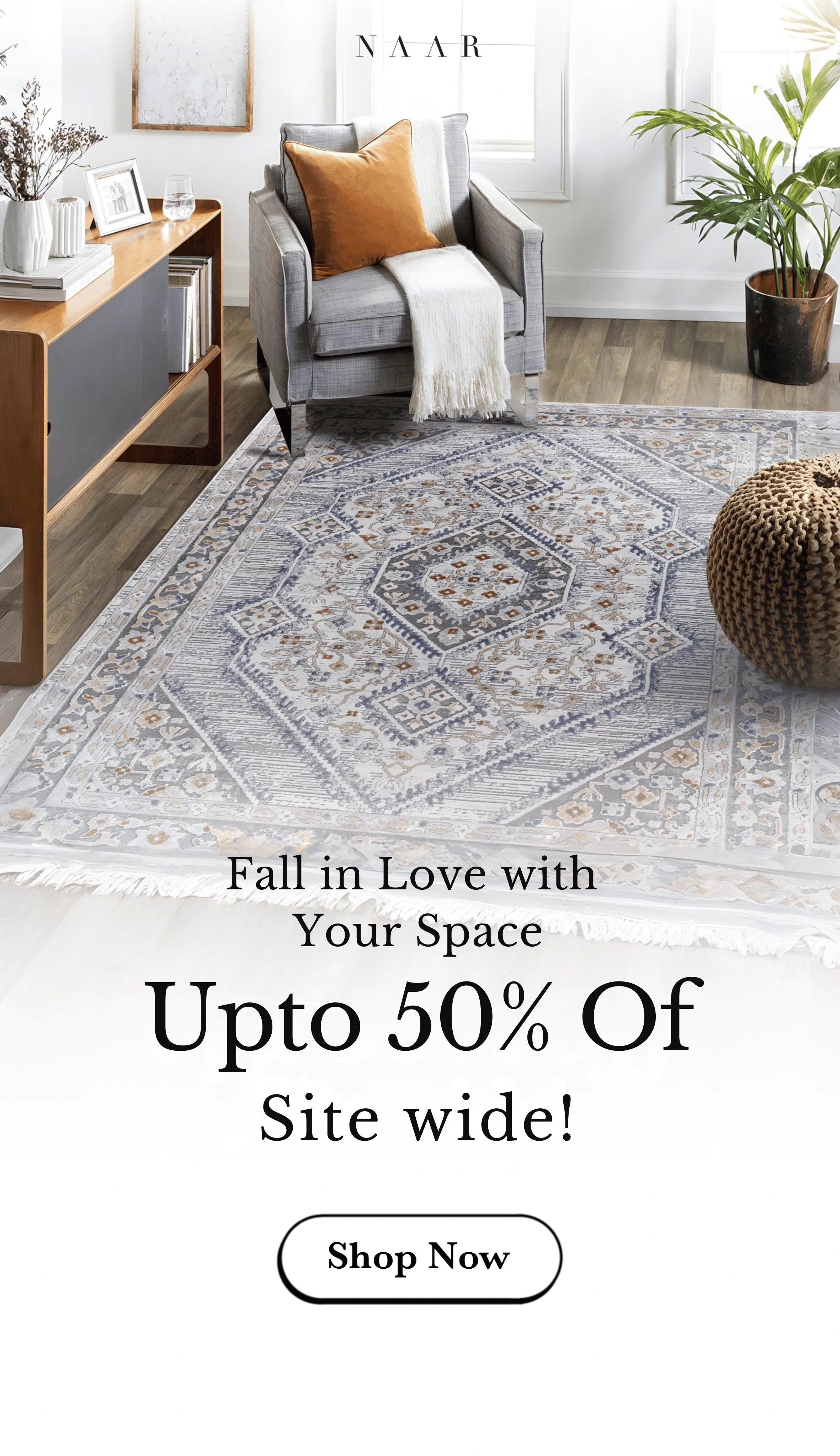 Living room with a rug, ottoman, and furniture, featuring a sale advertisement for Naar Rugs.